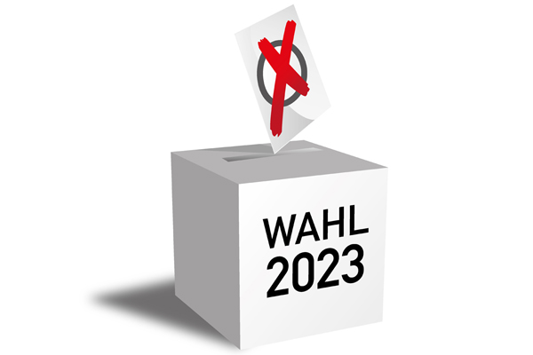 eine Wahlurne mit dem Text Wahl 2023 und einem großen Kreuz auf einem Zettel